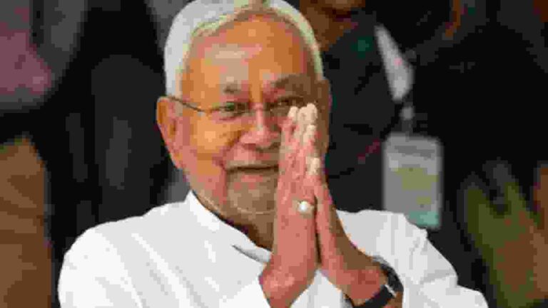 Nitish Kumar greeting supporters during Bihar elections.