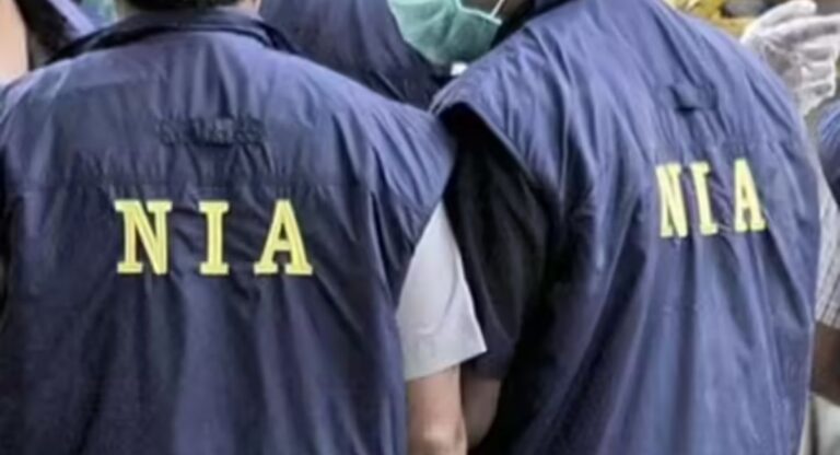 NIA officials in jackets during a drug trafficking operation