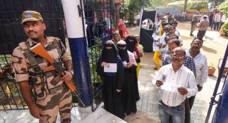 Voters waiting in line at a polling station in Bihar.