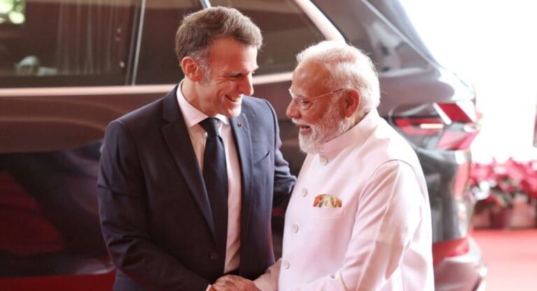 PM Modi and President Macron greet each other in Mumbai.