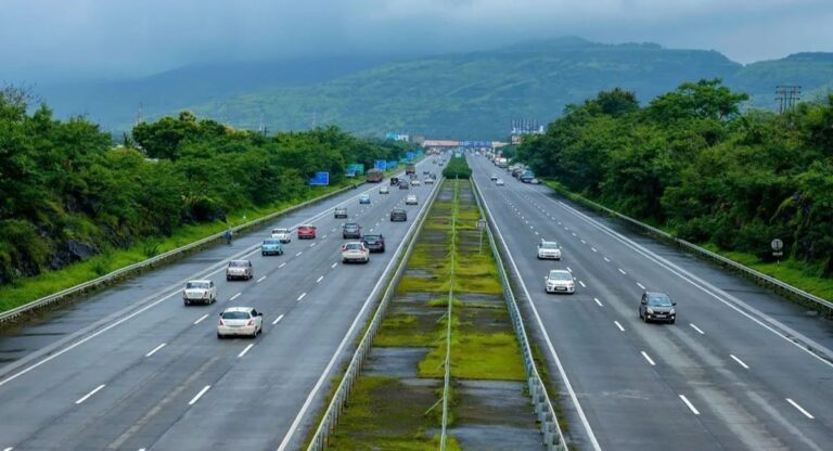 National highway with green surroundings and vehicles